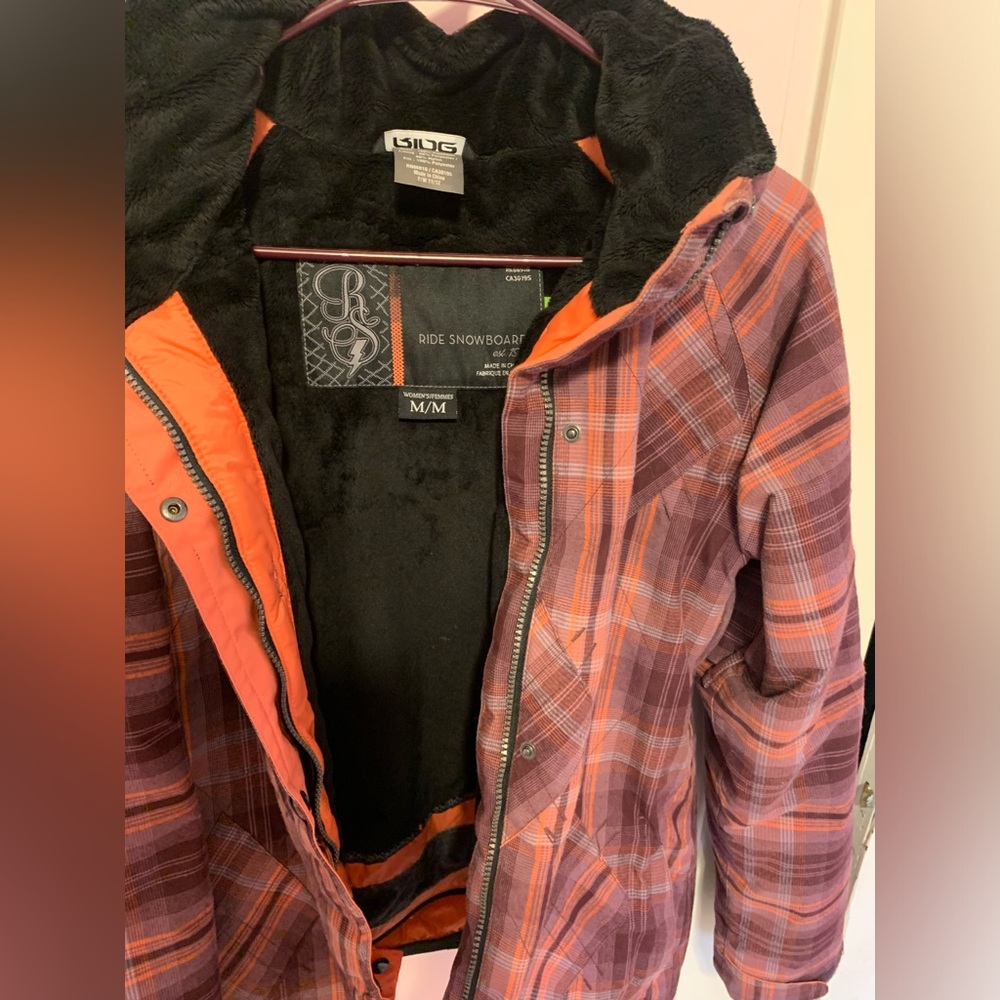 Ride Snowboard brand women’s ski/snowboard jacket. Colors are oranges and purple